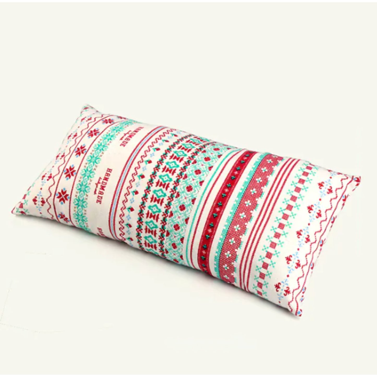 Close up of boho camping pillow bold ethnic zigzag geometric pattern in navy, pink, blue, red and white on cotton cover