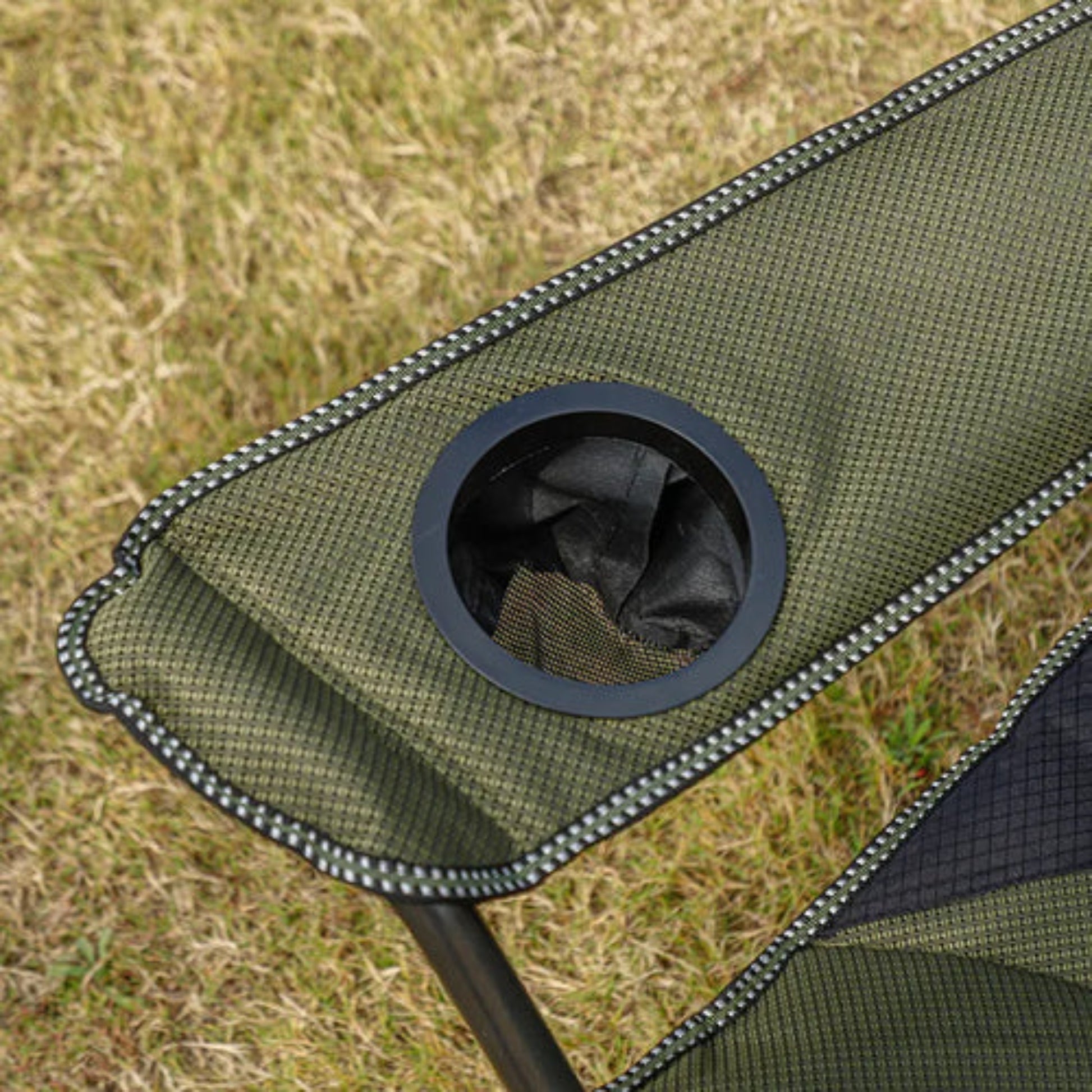 Heavy duty high-back camp chair in olive and black with padded headrest, cup holder on armrest and front side storage pockets