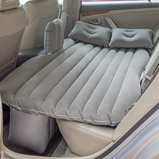 Inflatable car mattress fitted across car back seat showing how contoured base sits over footwells for flat sleeping surface