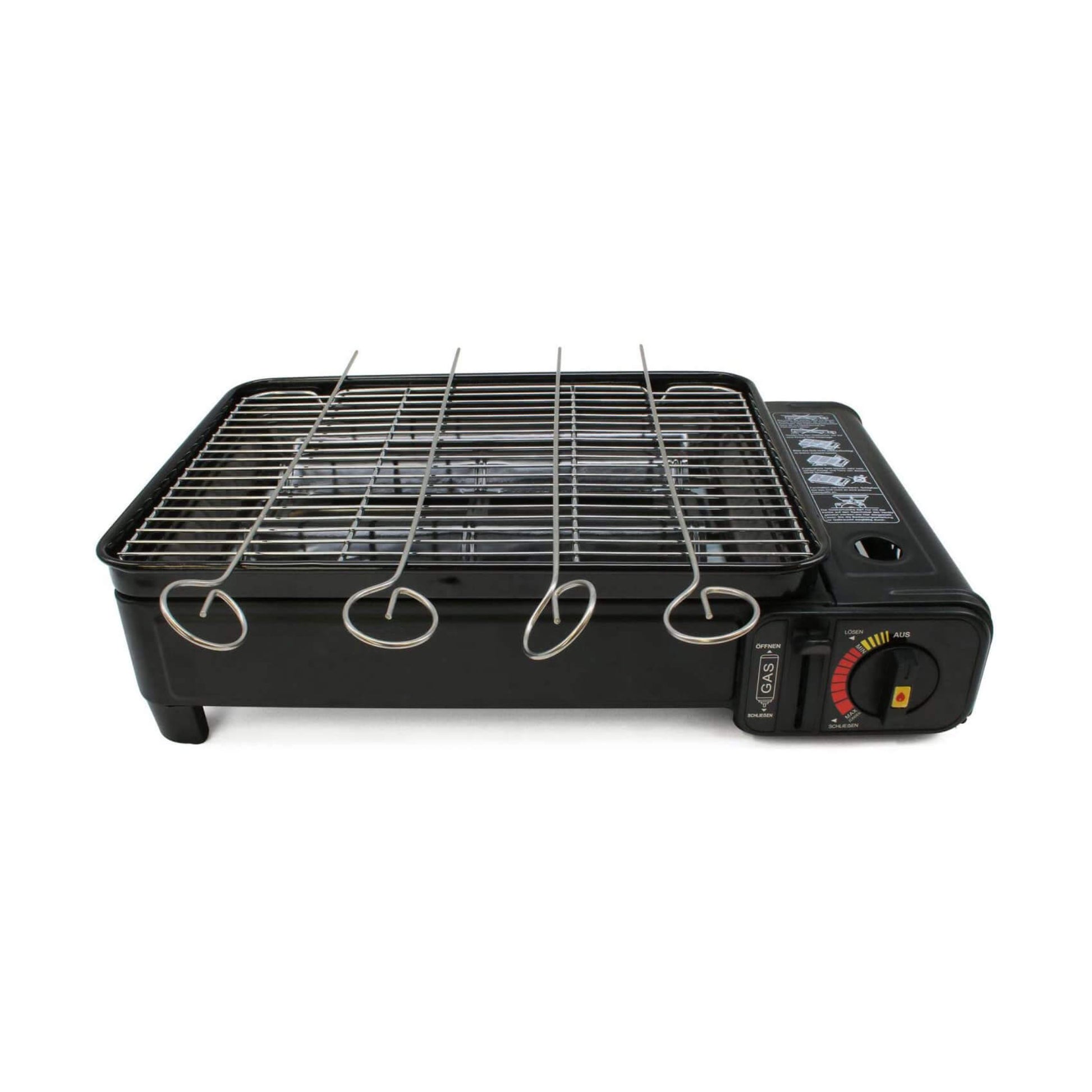 Black portable grill with metal skewers on a white background