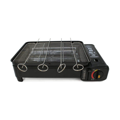 Black portable grill with metal skewers on a white background