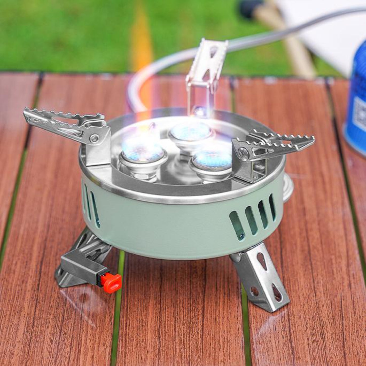 Close up of STARCAMP round camping stove sage green aluminium base with ventilation slots and stainless steel body