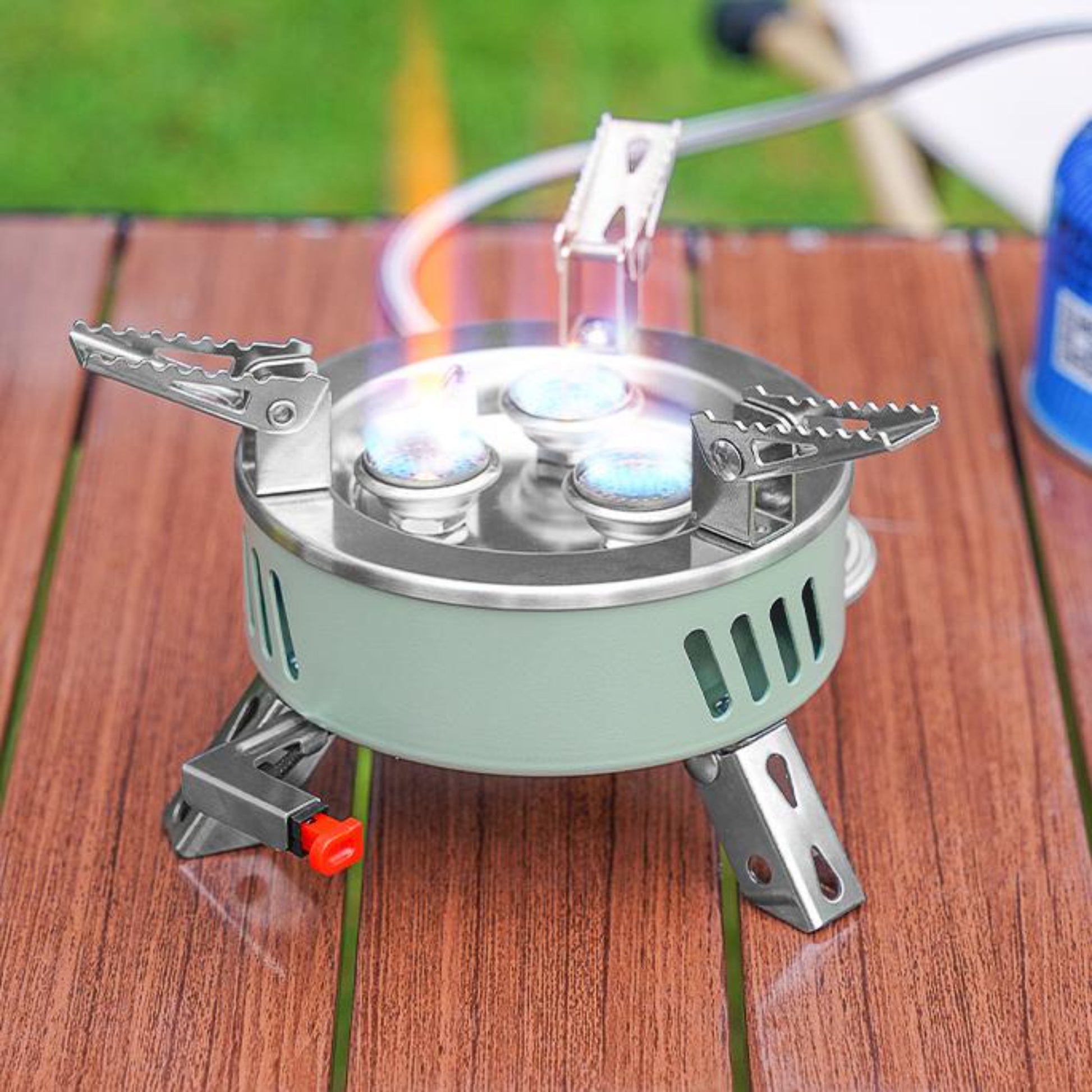 Close up of STARCAMP round camping stove sage green aluminium base with ventilation slots and stainless steel body