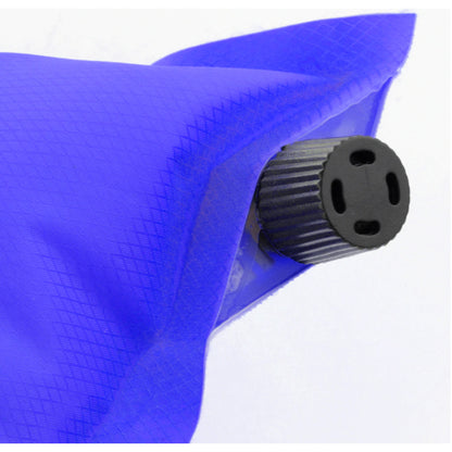 Self-inflating camping pillow in use inside tent at campsite showing comfortable head support for backpacking and outdoor sleep