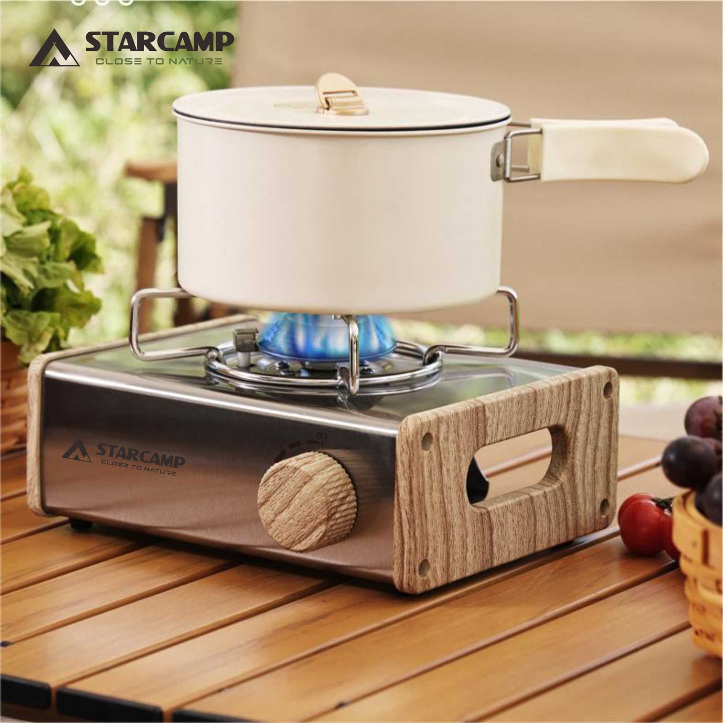 Starcamp portable stove with a pot on a wooden surface outdoors