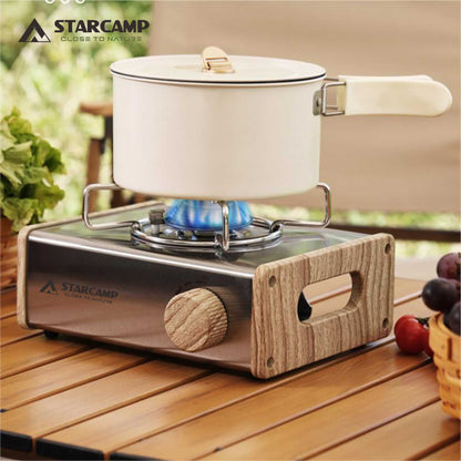 Starcamp portable stove with a pot on a wooden surface outdoors
