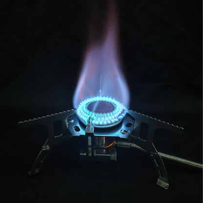 Close-up of a gas stove burner with flames on a black background